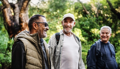 Three friends enjoying a cheerful moment on a nature walk