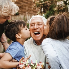 Happy family celebrating a birthday together outside