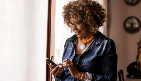Woman using tablet by the window