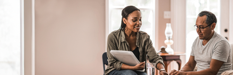 Woman showing man how to use pill planner