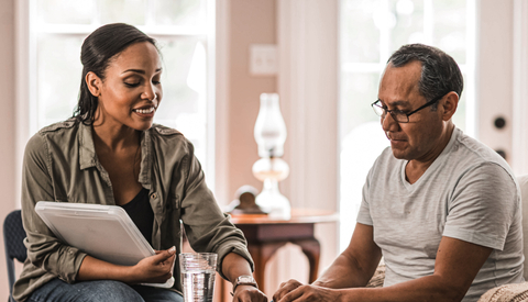 Woman showing man how to use pill planner