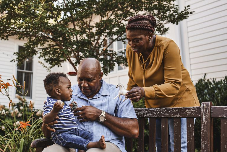 Toddler�sitting with his grandparents outside