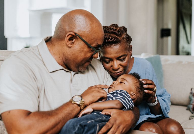 Mature grandparents at home looking after grandchildren