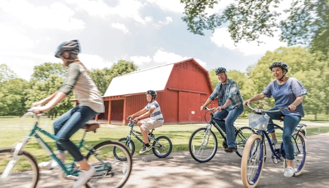 Grandparents and their grandchildren on a bike ride.