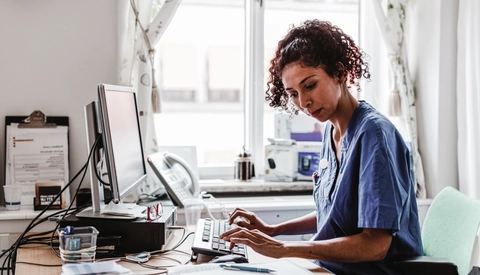 Medical Professional Working on Computer