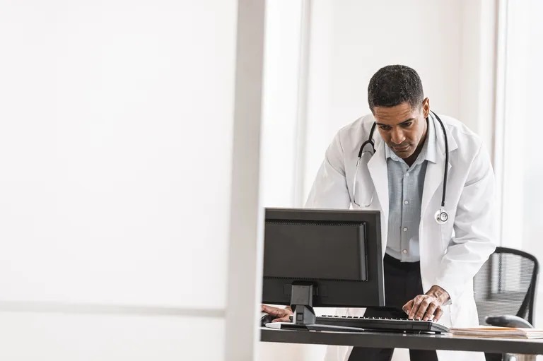 Male doctor using computer in his office