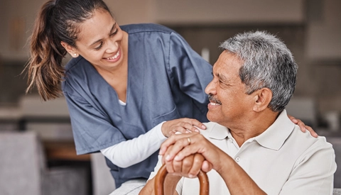 Nurse helping elderly patient in assisted living home