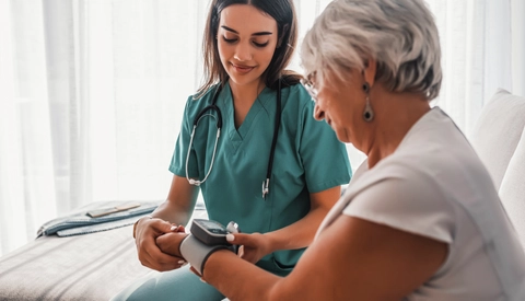 Female Medical Provider Checking A Patient's Blood Pressure