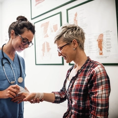 Female Doctor Treating Female Patient's Injury