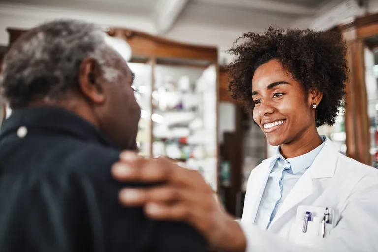Young Doctor Smiles While Talking To Patient