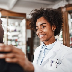 Young Doctor Smiles While Talking To Patient