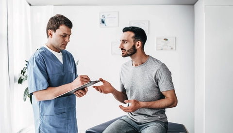 Patient talking to Doctor in medical setting