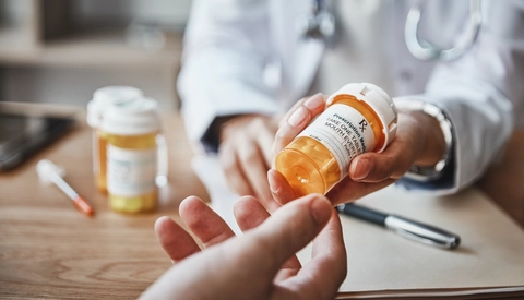Doctor handing medication to patient