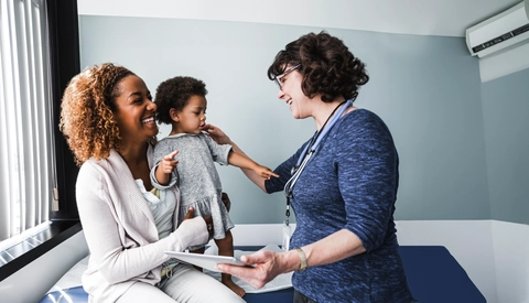 Mother and young child with Pediatrician