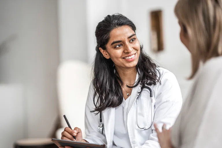 Female Physician talks to patient