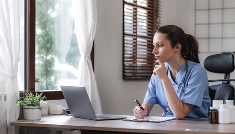 Medical provider working on laptop computer