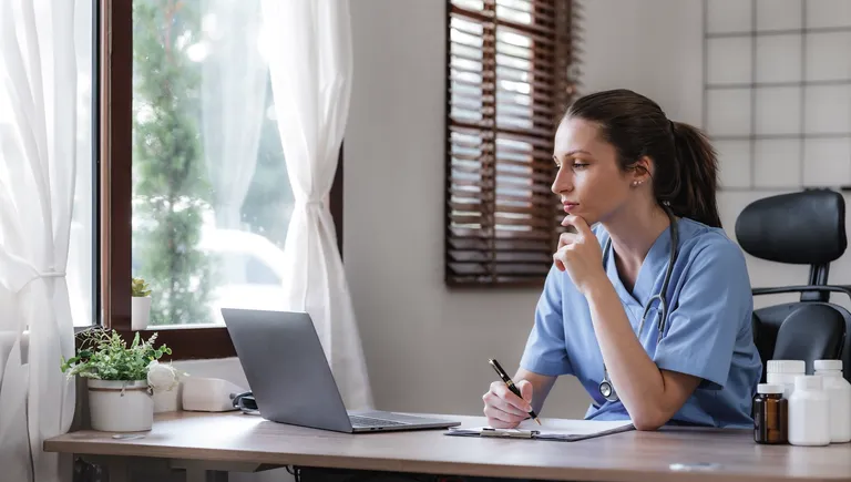 Medical provider working on laptop computer
