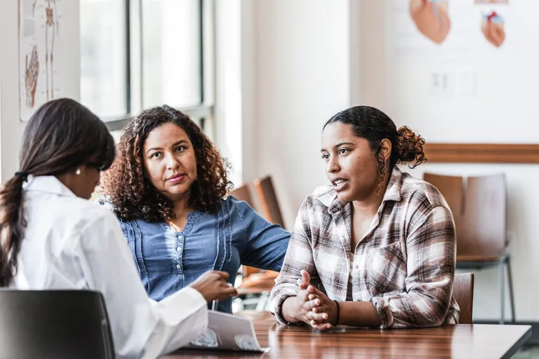 Mother and Young Adult Daughter talk to Doctor
