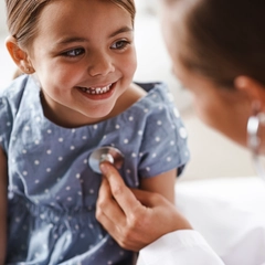 Female Doctor examining young girl