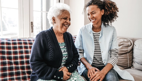 A Young Woman Providing In Home Care For An Elderly Woman
